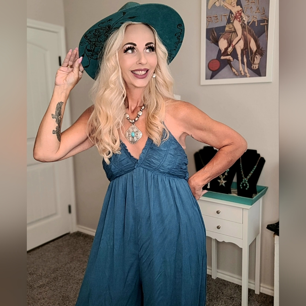 Blue, flowing jumpsuit with tie in back. Has pockets.